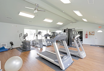 a gym with a lot of exercise equipment